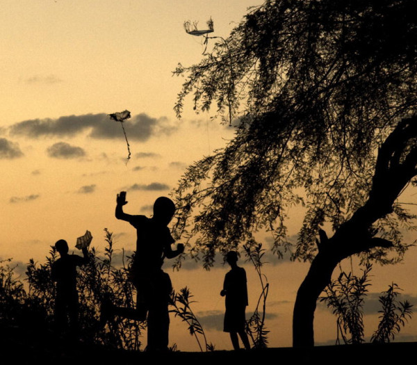 Children fly their kites at sunset inside the Petionville Club, the former Port-au-Prince golf resort now used as a sprawling campground for displaced Haitians.