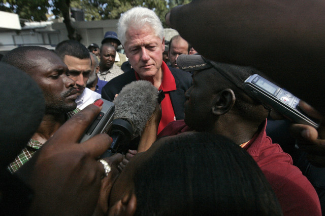 William J. Clinton (centre), UN Special Envoy for Haiti and former President of the United States of America, is swamped by reporters in Port-au-Prince, Haiti, after his meeting with Haitian President René Garcia Préval. Mr. Clinton and Mr. Préval met at the Direction Centrale de la Police Judiciaire (DCPJ), Haiti's investigation bureau which serves as government headquarters since the collapse of the Presidential Palace.