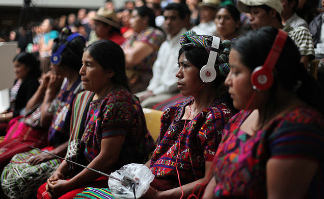 Mayan Ixil Indian women listen to Spanish-Ixil translation of court proceedings during Efrain Rios Montt's genocide trial (Photo credit: Bobertson https://www.flickr.com/photos/9975353@N03/ ).
