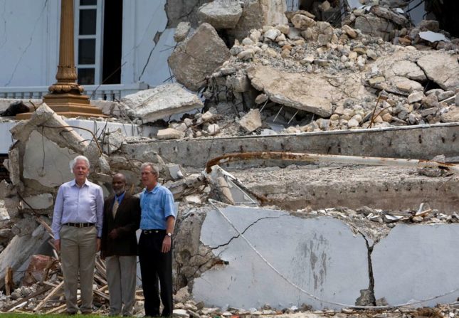 Former Presidents Bill Clinton and George Bush and Haitian President Rene Preval visit the collapsed National Palace after a press conference. Presidents Clinton and Bush are in Haiti for one day visit. Photo Marco Dormino
